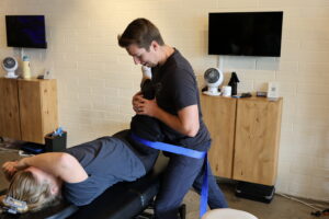 physical therapist working on patients leg