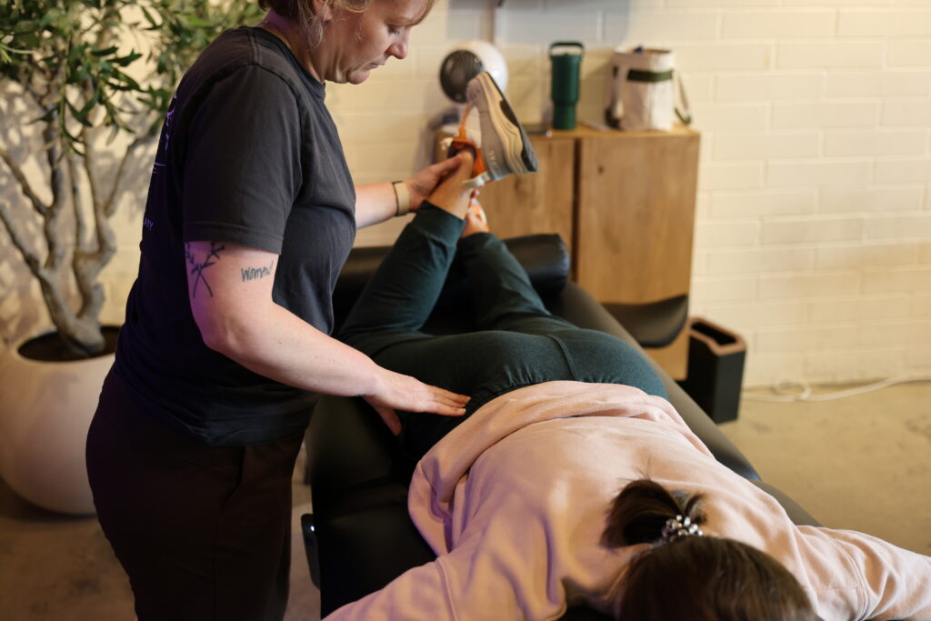 physical therapist working on clients hip