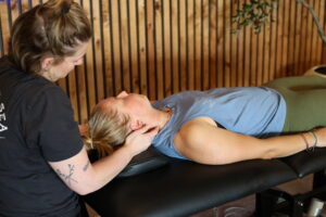 physical therapist working on clients neck