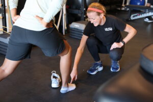 physical therapist with client working on heel